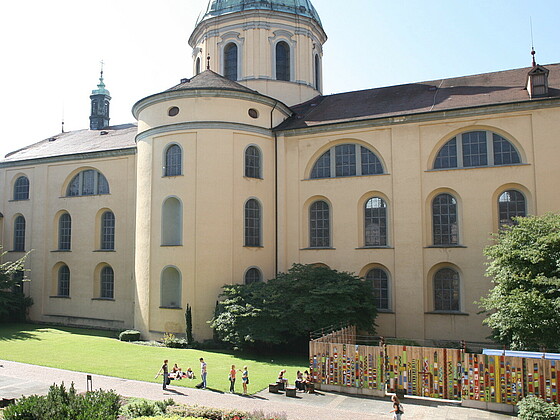 Students enjoying a sunny day in the basilica courtyard at our university